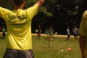 Tournament competitor lands a disc in the basket during the Ring of Fire